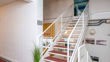 A staircase with white railings leading to an upper floor.