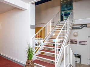 A staircase with white railings leading to an upper floor. - 4 Person Holiday Home in Hejls (Hejls)