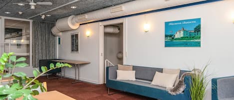 A modern interior with a sofa, a table, and a poster on the wall.