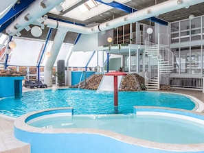 An indoor swimming pool with a slide, a staircase, and lounge chairs. - 4 Person Holiday Home in Hejls (Hejls)