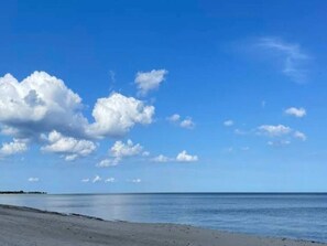 A beach with a clear sky and calm sea. - 5 Person Holiday Home in Vaeggerlose (Vaeggerlose)