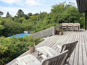 A wooden deck with outdoor seating and a pool. - 4 Star Holiday Home in Ebeltoft (Ebeltoft)