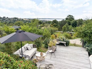 A wooden deck with outdoor furniture, including a sofa, chairs, and a table. - 4 Star Holiday Home in Ebeltoft (Ebeltoft)