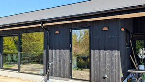 A modern building with large windows and a dark exterior. - 6 Person Holiday Home in Juelsminde-by Traum (Juelsminde)