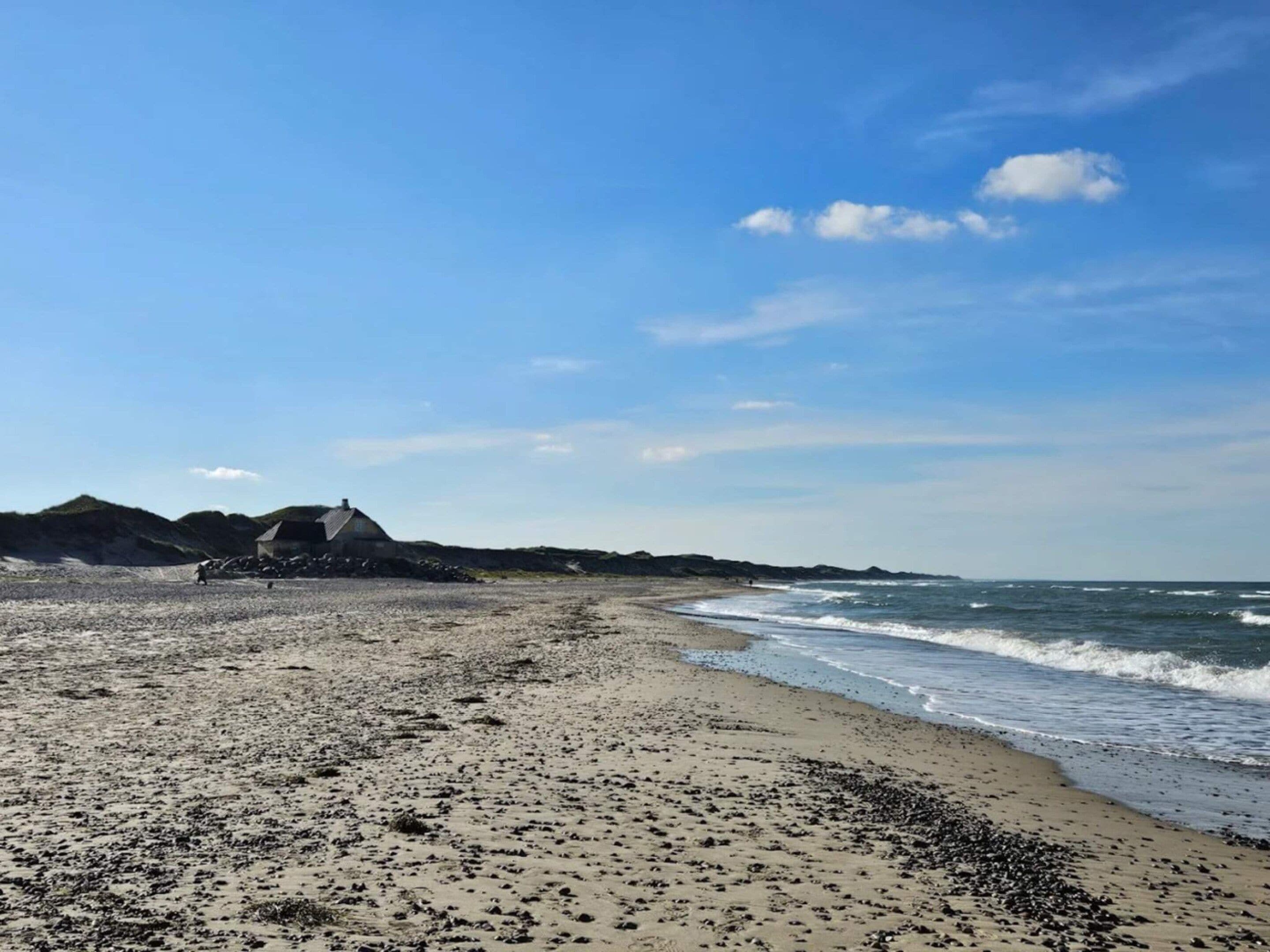 A beach with a building in the background.