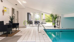 A swimming pool area with a covered patio, outdoor seating, and a view of the outdoors. - 8 Person Holiday Home in Albaek (Aalbaek)