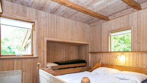 A wooden room with a bunk bed, a window, and a wall-mounted heater. - 6 Person Holiday Home in Hovborg (Hovborg)