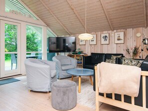 A modern living room with a TV, grey sofas, a black sofa, and a wooden ceiling. - 6 Person Holiday Home in Hemmet (Hemmet)