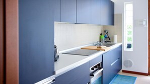 A modern kitchen with blue cabinets, a white countertop, and a built-in oven. - Blue Bellagio by Wonderful Italy (Bellagio)