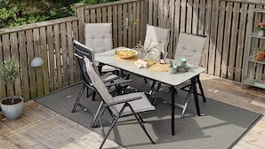 A wooden deck with a table and chairs under a canopy. - 4 Star Holiday Home in Lysekil (Lysekil)