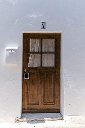A wooden door with a number plate indicating it is number 7.