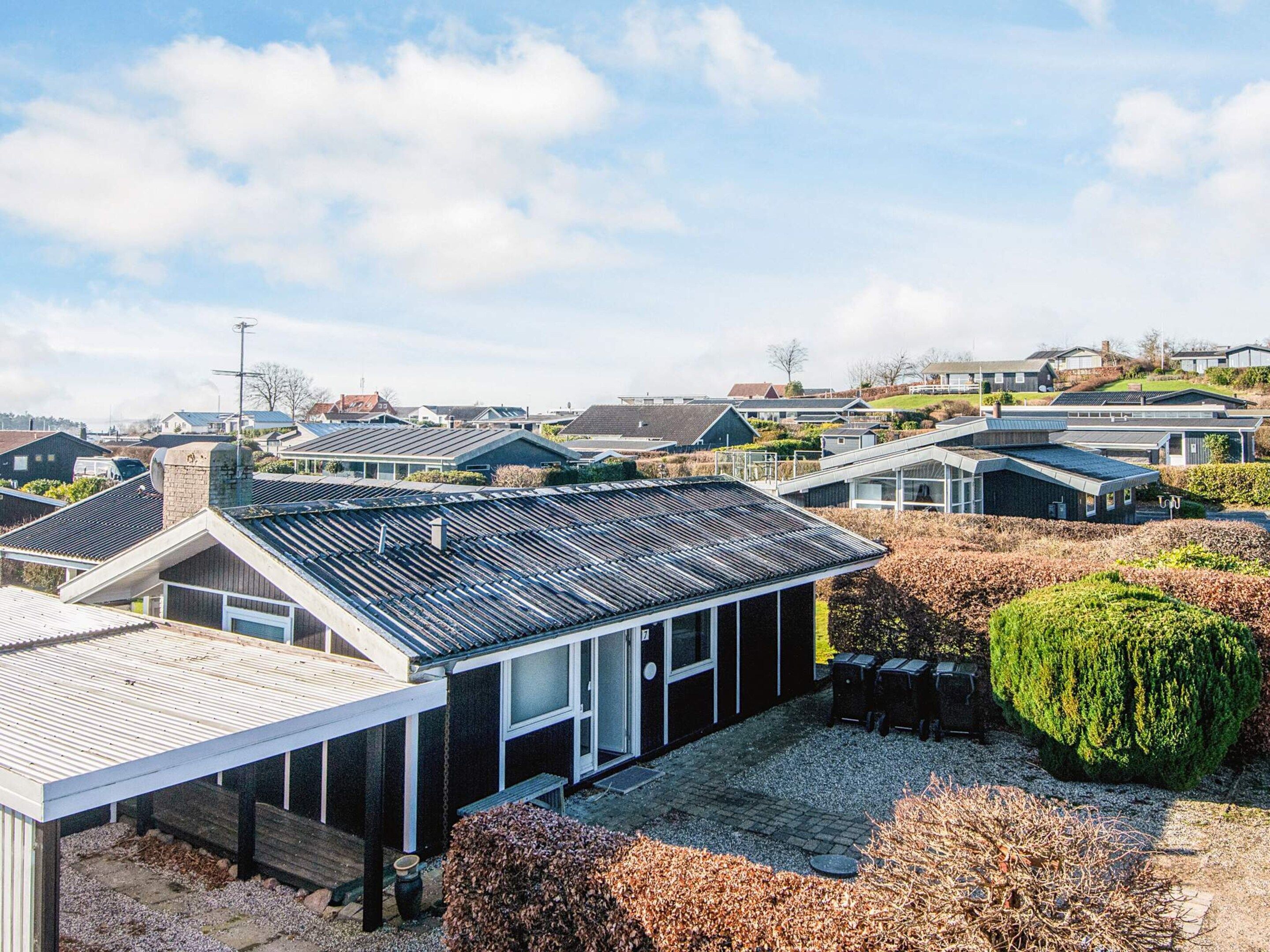 A residential area with modern houses, a covered patio, and a well-maintained garden.