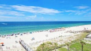 A beach with a wooden boardwalk, white sand, and a clear blue sky. - GulfSide Oasis-On The Beach (Pensacola)