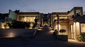 A modern residential building with a central pathway leading to a covered entrance. - Kaktus Suites Private Pool (Kassandra)