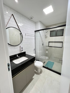 Apartment | Bathroom | Shower, rainfall showerhead, hair dryer, soap
