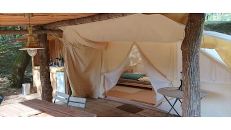 Outdoor dining. Large furnished tent in the heart of nature