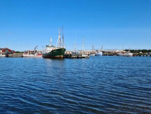 A harbor with several boats docked, a clear sky, and a calm sea. - 6 Person Holiday Home in Vestervig (Vestervig)