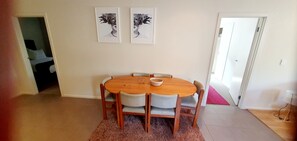 Enjoy meals in this dining area with a round table and six chairs, surrounded by framed artworks.