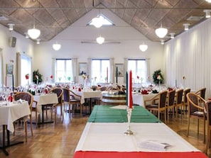 A spacious dining hall with multiple tables set for a formal event, featuring a central aisle and a high ceiling with exposed beams. - 5 Person Holiday Home in Hovborg (Hovborg)