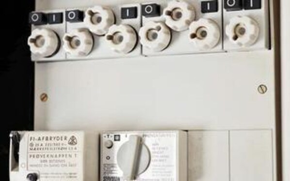 A control panel with multiple switches and a manual.