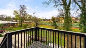 A view from a balcony overlooking a sports field with a building in the background. - 5 Minutes From Downtown Atlanta (Atlanta)