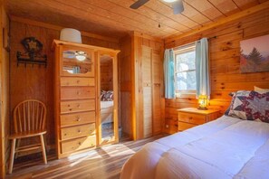 Relax in this serene bedroom with a comfortable bed, bedside table, and wardrobe.