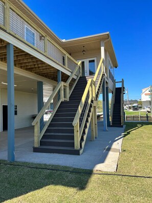 A building with a central staircase, multiple floors, and a covered outdoor area. - Waterfront Paradise (Bay St. Louis)