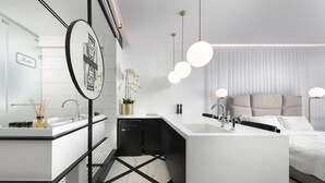 A modern bathroom with a large mirror, two sinks, a toilet, and a shower area. - King George Suites (Jerusalem)