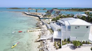 A coastal property with a large house, a dock, and kayaks. - Luxury oceanfront villa 1BR, protected dock, private & gated peninsula (Marsh Harbour)