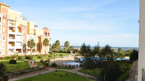 A hotel with multiple floors, a swimming pool, and a view of the beach. - Los Cisnes 77 - Two Bedroom Apartment, Sleeps 5 (Punta del moral)