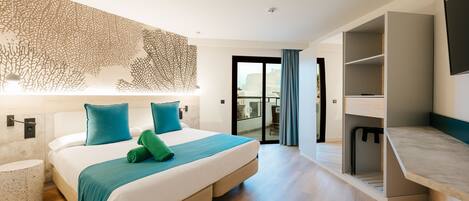 A modern hotel room with a large bed, a built-in desk, and a balcony with a view.