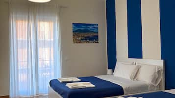 Deluxe Quadruple Room | Premium bedding, memory foam beds, individually furnished, desk