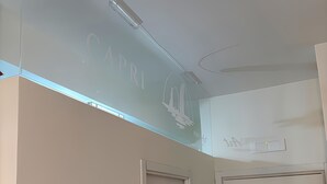 A room with a ceiling light fixture and a door.