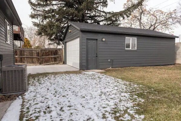 Standalone home with a front yard and a large evergreen tree.