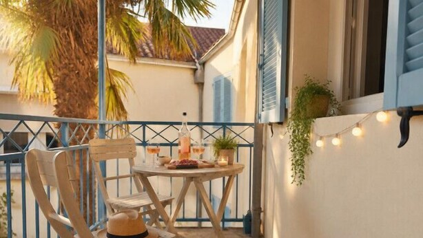 A balcony with a table, chairs, and a potted plant. - Bright and well decorated nest in La Rochelle (La Rochelle)