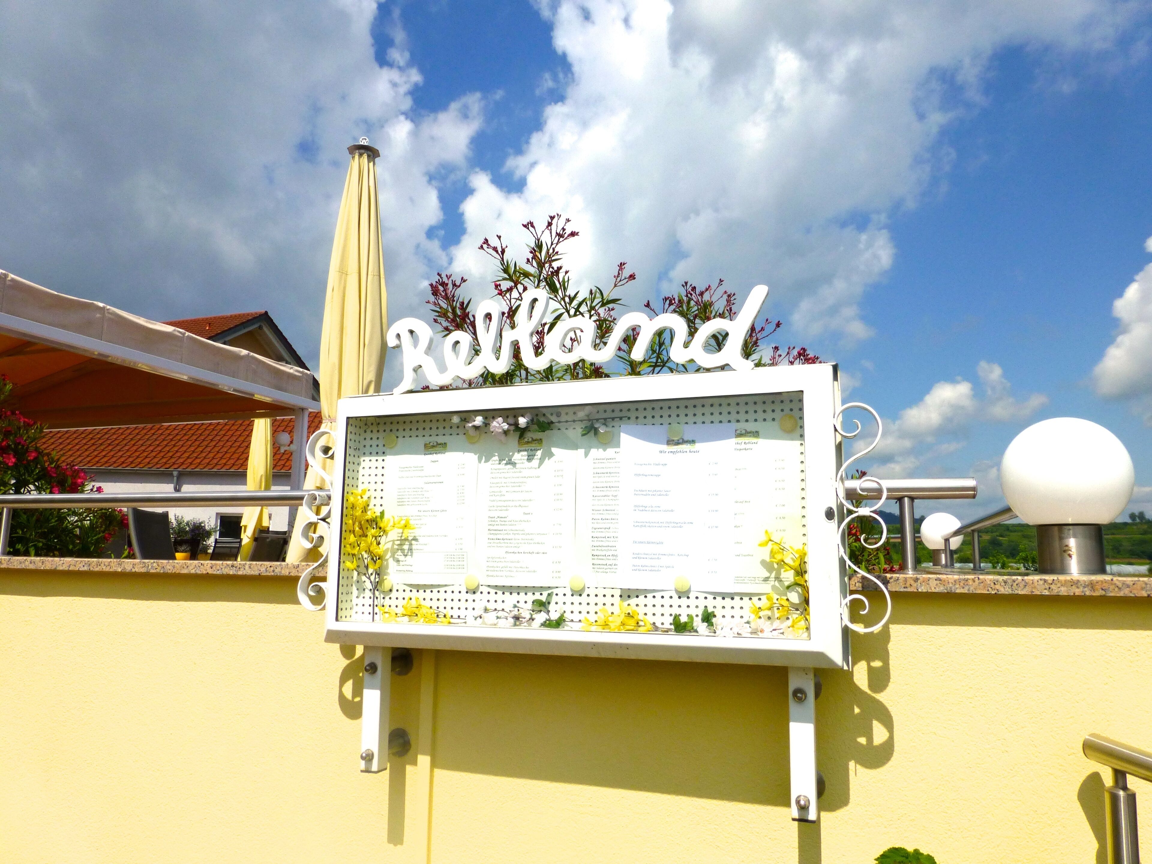 A signboard with the name 'Reitland' and a menu listing.