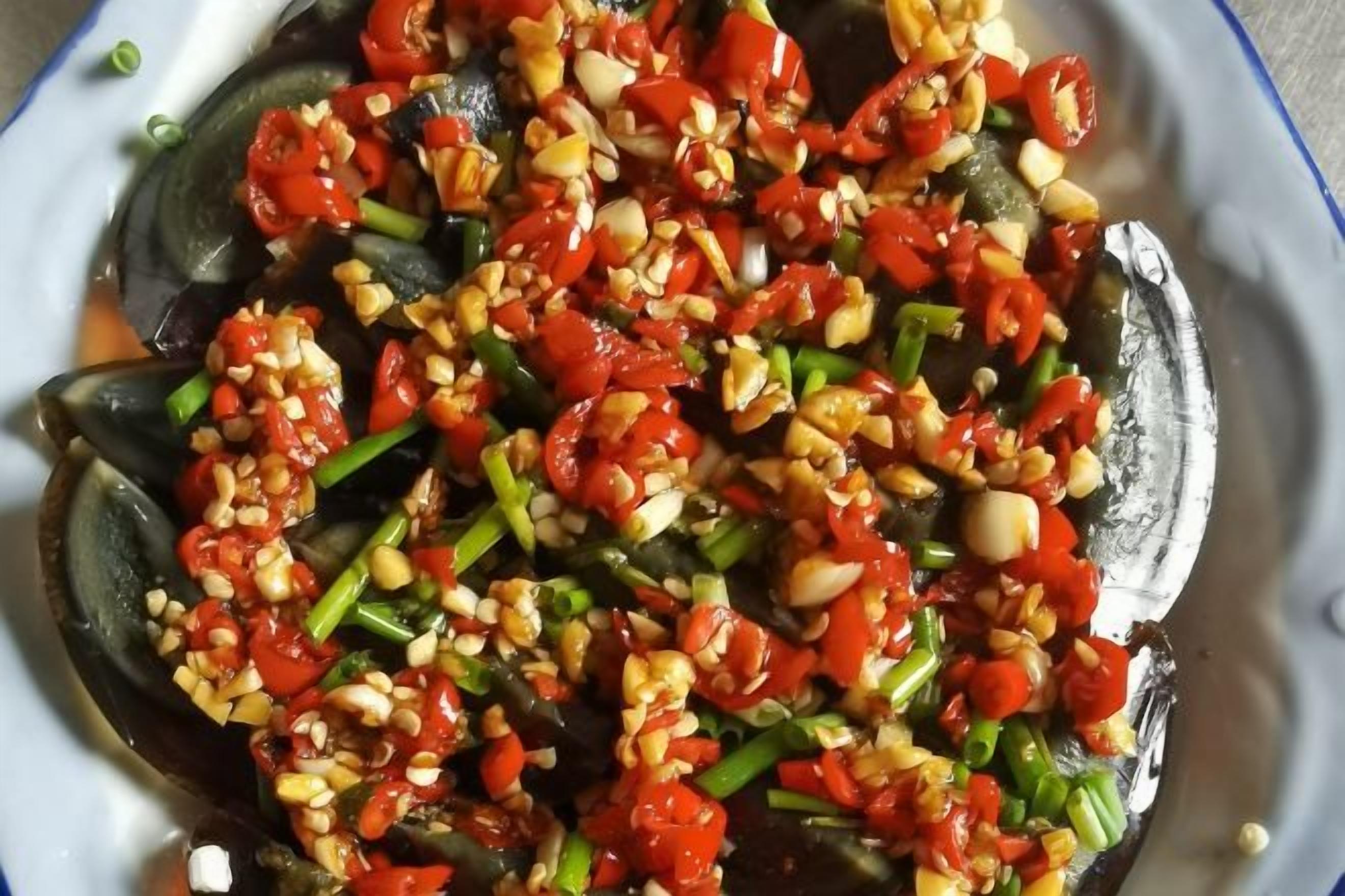 A plate with sliced vegetables and nuts.
