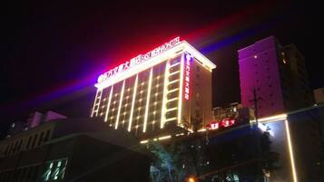 A multi-story hotel building with illuminated signage at the top.