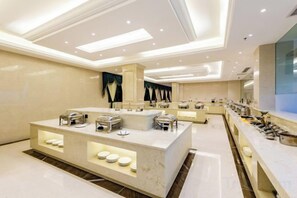 A modern hotel lobby with a central reception desk, multiple seating areas, and a large mirror reflecting the space. - Nujiang East Wenhao hotel (Lushui)