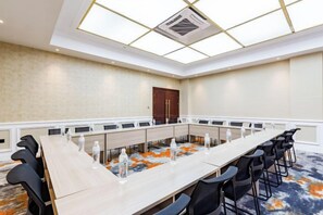 A conference room with a long table, chairs, and a ceiling light fixture. - Nujiang East Wenhao hotel (Lushui)
