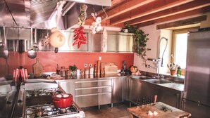 A modern kitchen with stainless steel appliances, wooden cabinets, and a central island. - Eco-gite Près de la Mer. 18 Couchages (Chiatra)