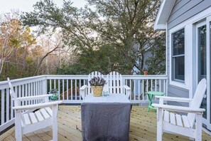 A wooden deck with a table and chairs, a potted plant, and a small table. - Sound Views, Pool, Hot Tub, Game Room, Club Access (Corolla)