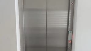 A closed elevator door with a control panel on the right side. - Condos TE22 (Cabo San Lucas)