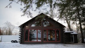 A log cabin with large windows and a small attached shed. - Mercer, WI Beautiful Flambeau Flowage Cabin (Butternut)
