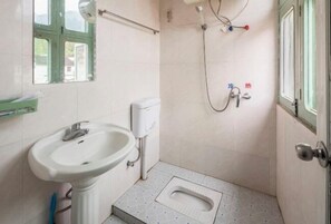 A small bathroom with a sink, toilet, and shower. - Qingyuan Farm Stay (Wuyuan)