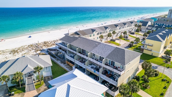 A beachfront hotel with multiple balconies, a pool, and a beach view. - 🏖️Private Beach Access-Gulf Views-Game Room-4BR Bonita Bay (Pensacola Beach)