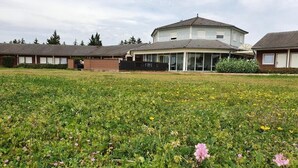 A residential area with a large house in the center, surrounded by smaller houses.