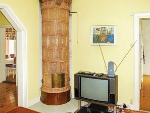 A room with a wooden pillar, a television, and a painting on the wall. - 7 Person Holiday Home in Algaras (Älgarås)