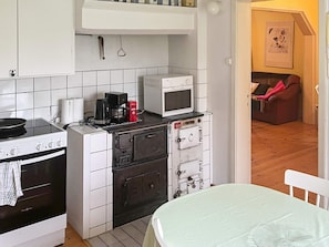 A compact kitchen with a stove, microwave, and a small oven. - 7 Person Holiday Home in Algaras (Älgarås)
