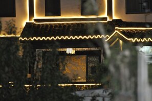 A traditional building with illuminated architectural details and a visible entrance. - Shushan Lanting Boutique Hostel (Suzhou)